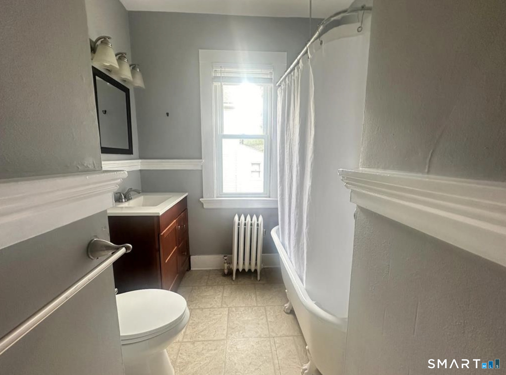 49 Dutton Street Wallingford, CT 06492 - Photo 10 of 10 a bathroom with a sink toilet a mirror and tub