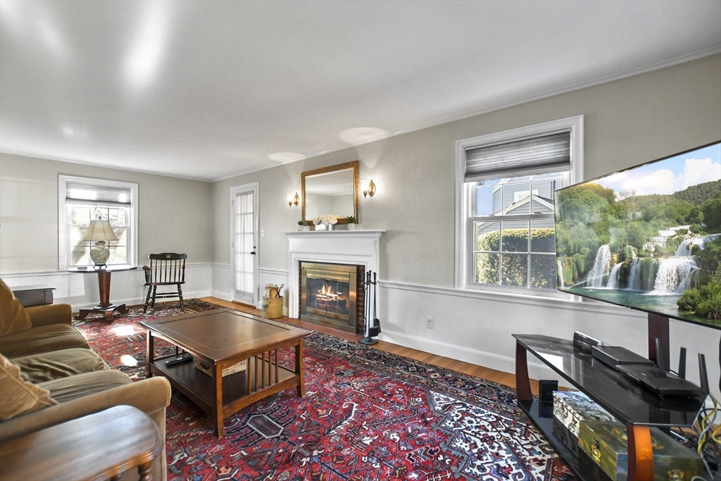 102 Channing Road Watertown, MA 02472 - Photo 18 of 40 a living room with furniture a fireplace and large windows