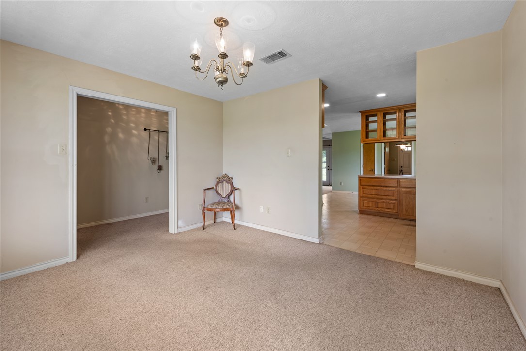9393 Locke Road Bryan, TX 77808 - Photo 11 of 39 a view of a hallway with wooden floor and entryway