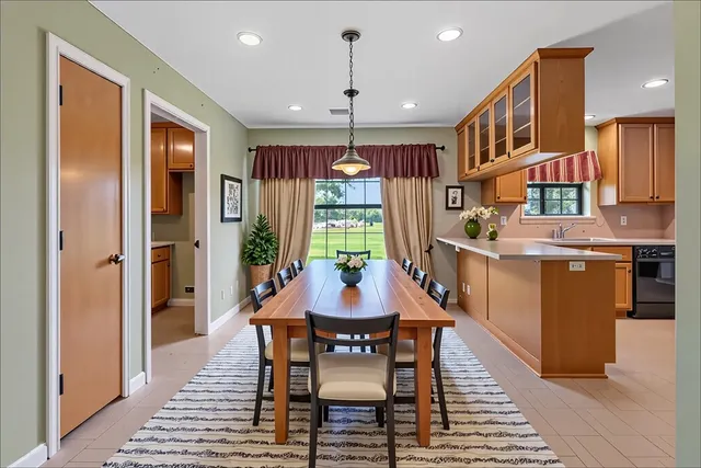 a dining room with furniture window and wooden floor