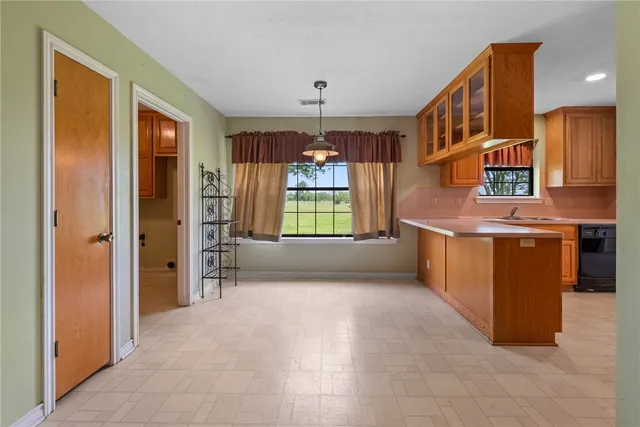 a view of a kitchen with a sink dishwasher and a refrigerator