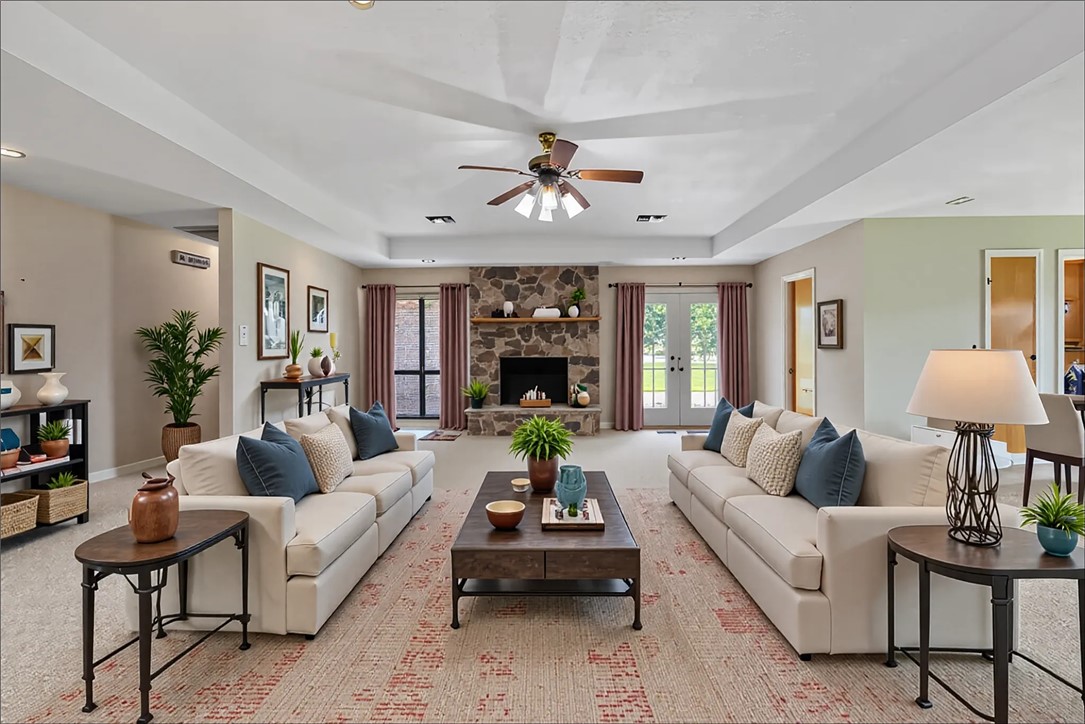 9393 Locke Road Bryan, TX 77808 - Photo 18 of 39 a living room with furniture a chandelier and a fireplace