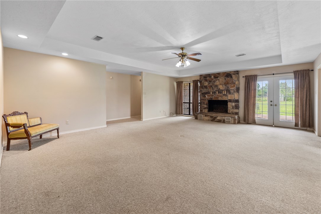9393 Locke Road Bryan, TX 77808 - Photo 20 of 39 a view of an empty room with a fireplace