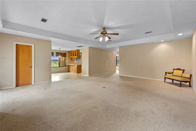 a view of a livingroom with a furniture and chandelier fan