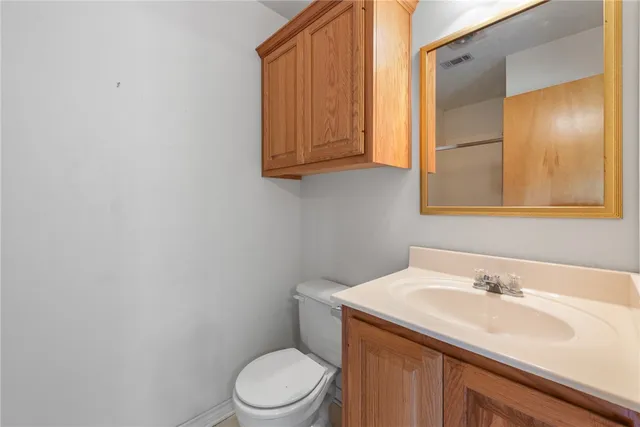 a bathroom with a toilet a sink and mirror