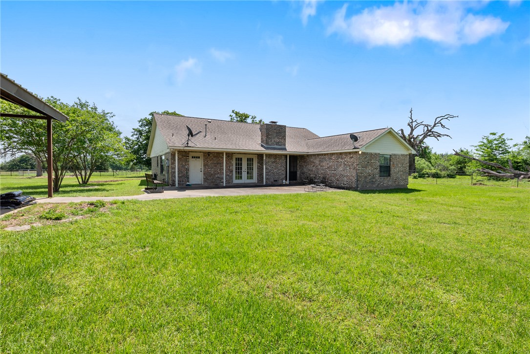 9393 Locke Road Bryan, TX 77808 - Photo 34 of 39 a view of a house with a big yard and large trees
