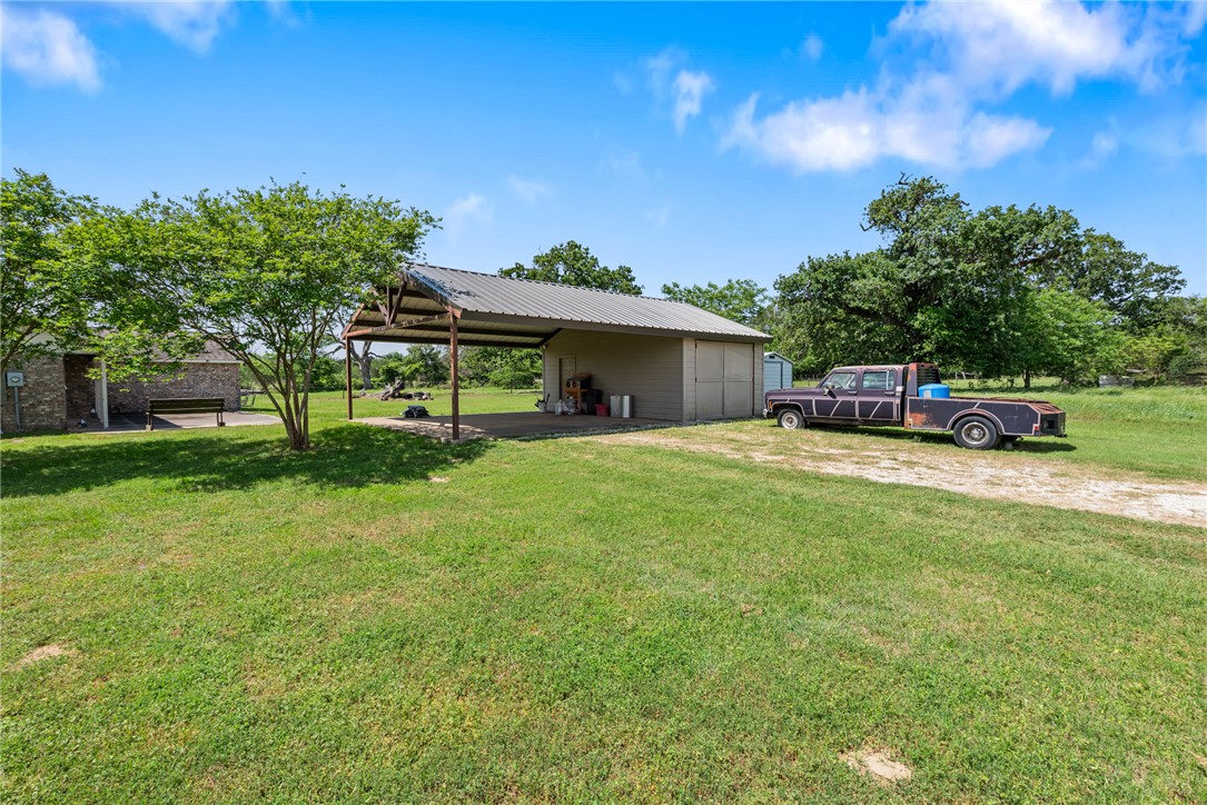 9393 Locke Road Bryan, TX 77808 - Photo 35 of 39 a front view of a house with a garden