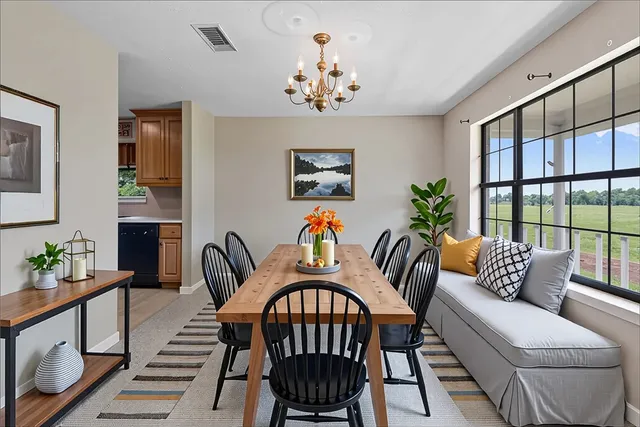 a living room with furniture a chandelier and a window