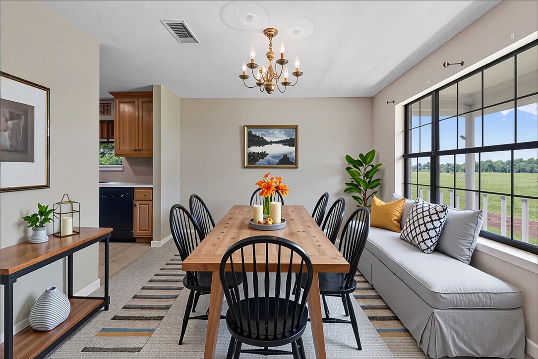 9393 Locke Road Bryan, TX 77808 - Photo 9 of 39 a living room with furniture a chandelier and a window