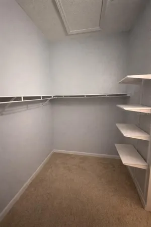 a view of a room with shelf on the wall