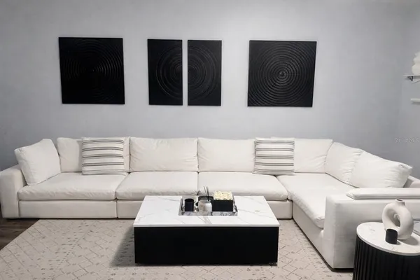 a living room with furniture and a lamp