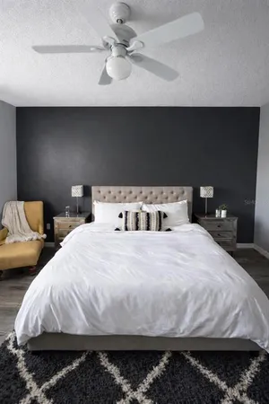a bedroom with bed and a chandelier