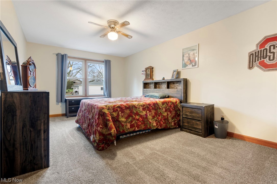 4915 Monticello Street Northwest Canton, OH 44708 - Photo 21 of 31 Bedroom with light colored carpet and ceiling fan