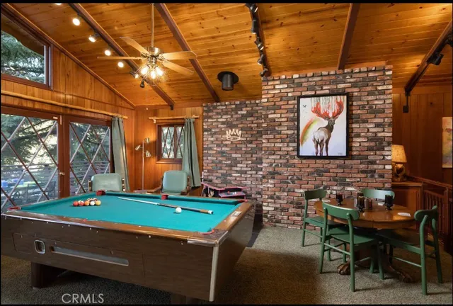 a kitchen with stainless steel appliances wooden cabinets a stove a sink and a microwave