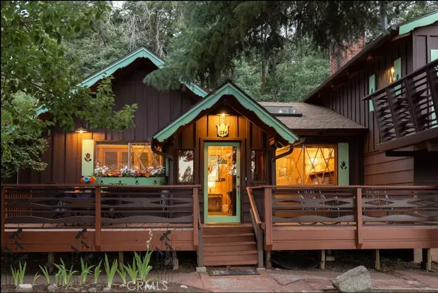 a living room with furniture a fireplace and paintings on the wall