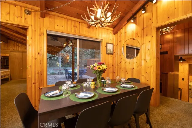 a bedroom with a bed and a dresser next to a window