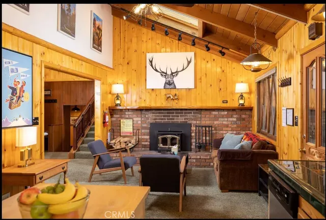 a living room with furniture a fireplace and a large window