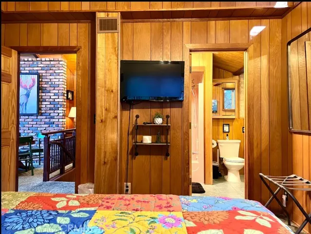 a bed room with a bed and a painting on the wall