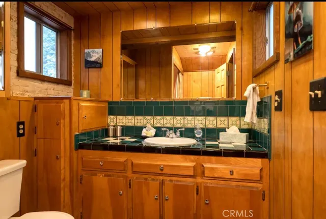 a view of walk in closet with clothes and toys