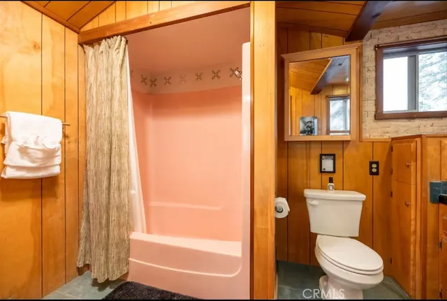 a bathroom with a toilet sink and shower