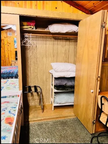 a view of a patio with table and chairs potted plants with wooden floor and fence