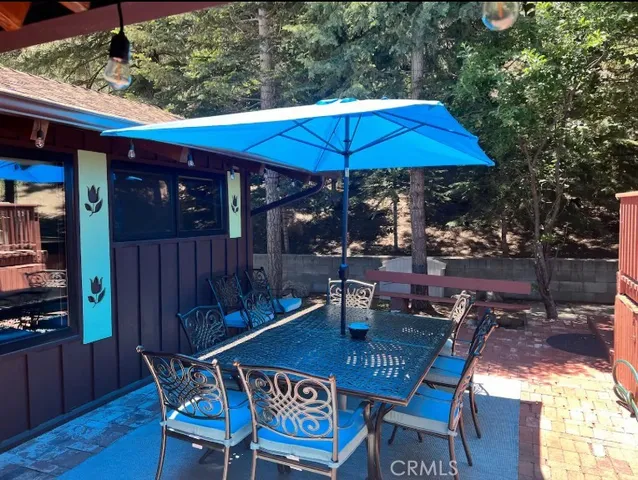 a backyard of a house with barbeque oven table and chairs
