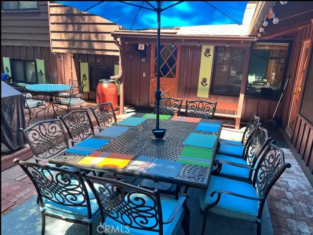 a balcony with chairs and a potted plant