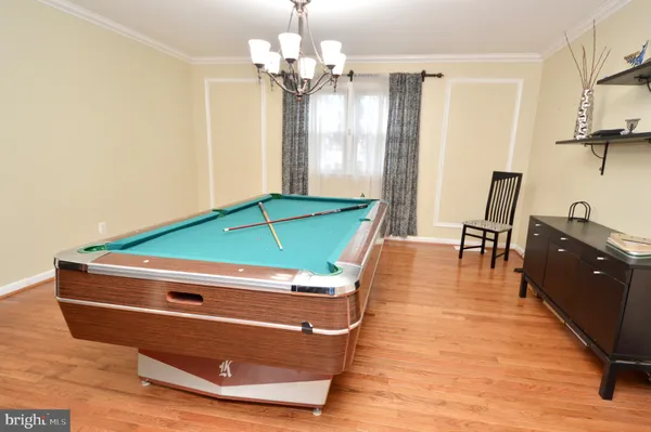 a room with wooden floors and lots of windows