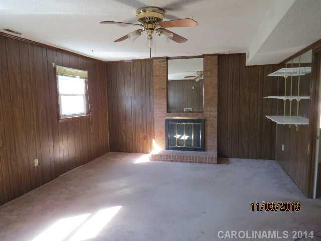 801 Riverwood Road Charlotte, NC 28270 - Photo 11 of 14 a view of an empty room with a fireplace and a window