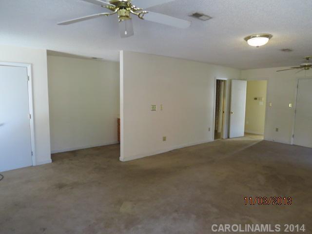 801 Riverwood Road Charlotte, NC 28270 - Photo 13 of 14 an empty room with a ceiling fan and a window