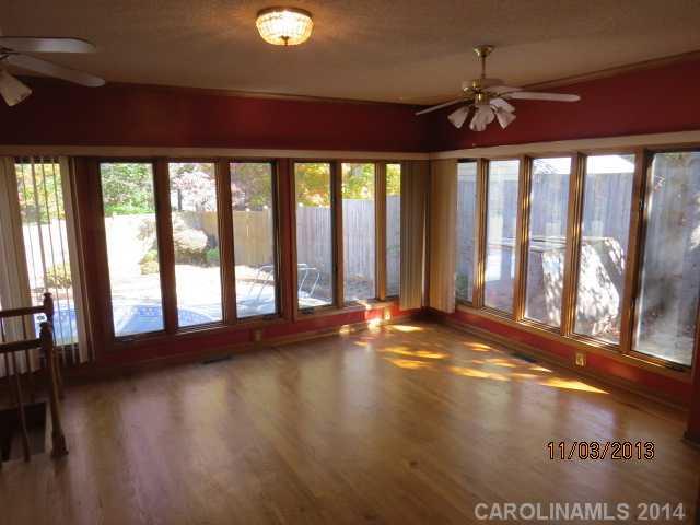 801 Riverwood Road Charlotte, NC 28270 - Photo 8 of 14 a view of an empty room with wooden floor and a window