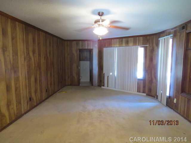 801 Riverwood Road Charlotte, NC 28270 - Photo 10 of 14 an empty room with windows and fan