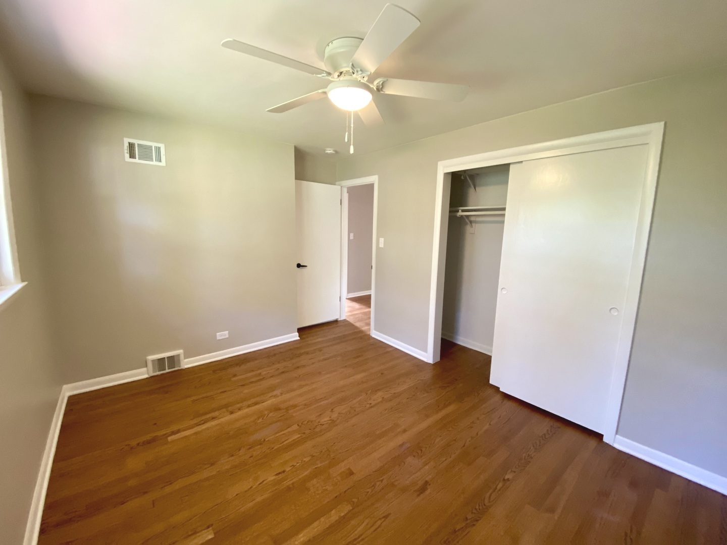3515 173rd Place Lansing, IL 60438 - Photo 22 of 26 an empty room with closet and a ceiling fan