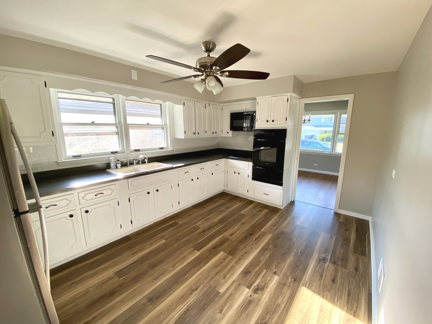3515 173rd Place Lansing, IL 60438 - Photo 10 of 26 a kitchen with granite countertop a sink cabinets stainless steel appliances and a window
