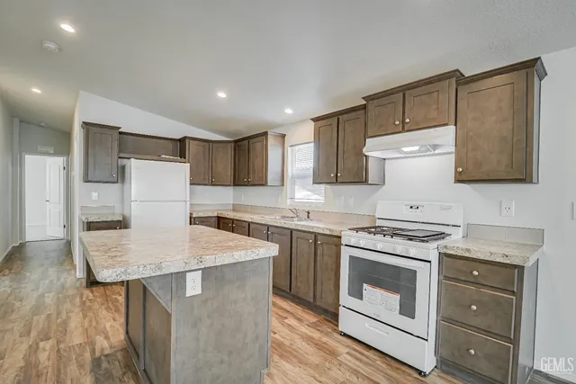 a kitchen with a stove a sink and a refrigerator
