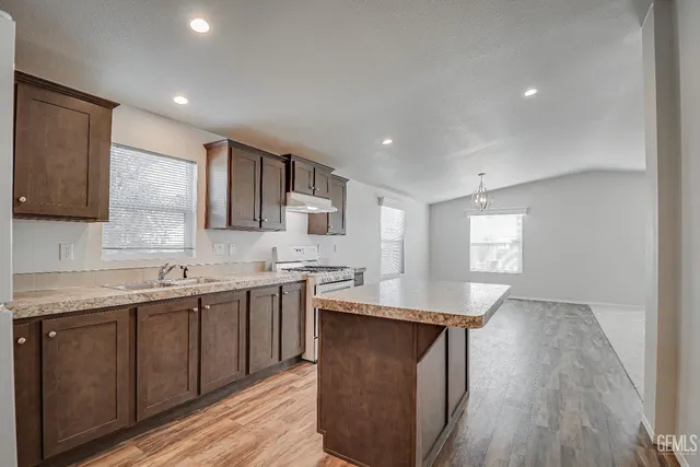 a kitchen with lots of counter space and sink