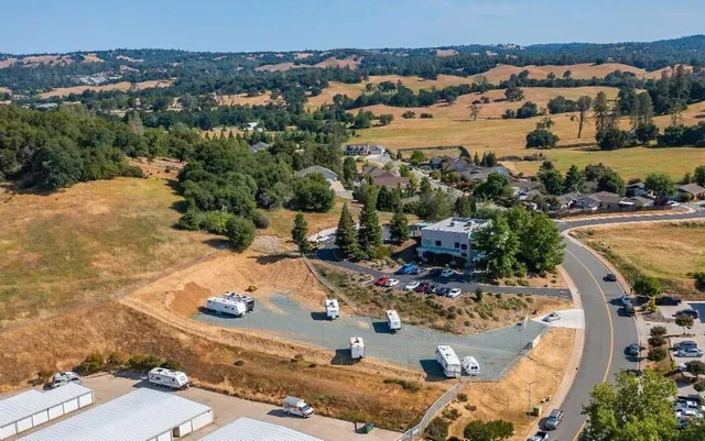 an aerial view of a house with a yard
