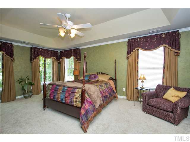 8909 Breeland Way Raleigh, NC 27613 - Photo 12 of 25 a bedroom with a bed couch and window