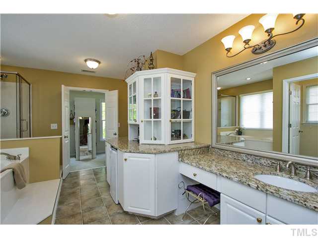 8909 Breeland Way Raleigh, NC 27613 - Photo 13 of 25 a bathroom with a granite countertop sink and a mirror