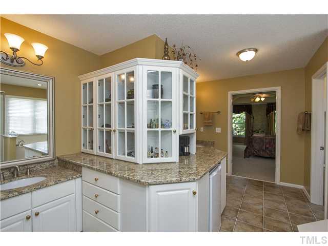 8909 Breeland Way Raleigh, NC 27613 - Photo 14 of 25 a kitchen with granite countertop sink and cabinets