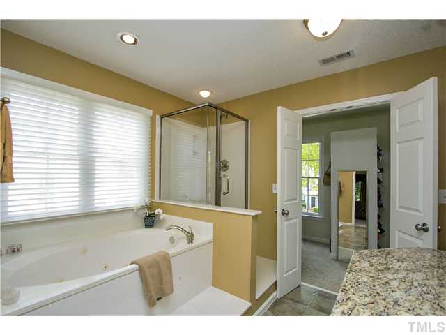 8909 Breeland Way Raleigh, NC 27613 - Photo 15 of 25 a bathroom with a bathtub and a sink
