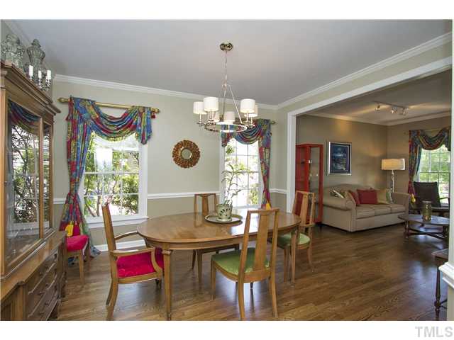 8909 Breeland Way Raleigh, NC 27613 - Photo 4 of 25 a view of a dining room with furniture and chandelier