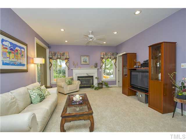 8909 Breeland Way Raleigh, NC 27613 - Photo 5 of 25 a living room with furniture and a fireplace