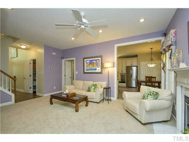8909 Breeland Way Raleigh, NC 27613 - Photo 6 of 25 a living room with furniture and a chandelier
