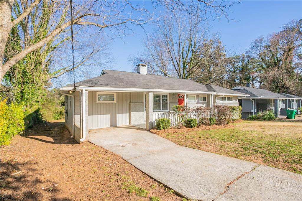 3449 Hyland Drive Decatur, GA 30032 - Photo 1 of 1 a front view of a house with a yard and garage