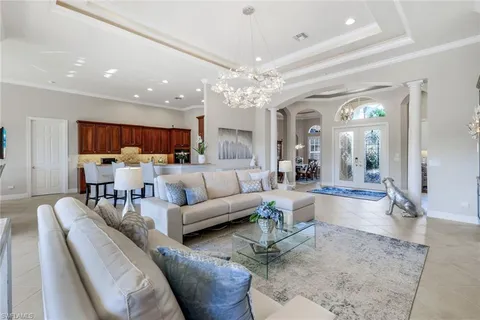 a living room with furniture or kitchen view and a chandelier