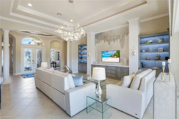 a living room with furniture and a chandelier