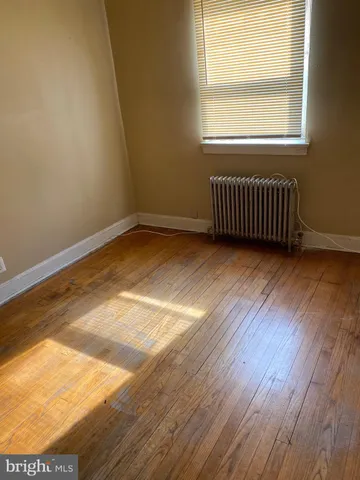 an empty room with wooden floor