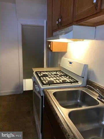 a view of a kitchen that has a sink and a stove