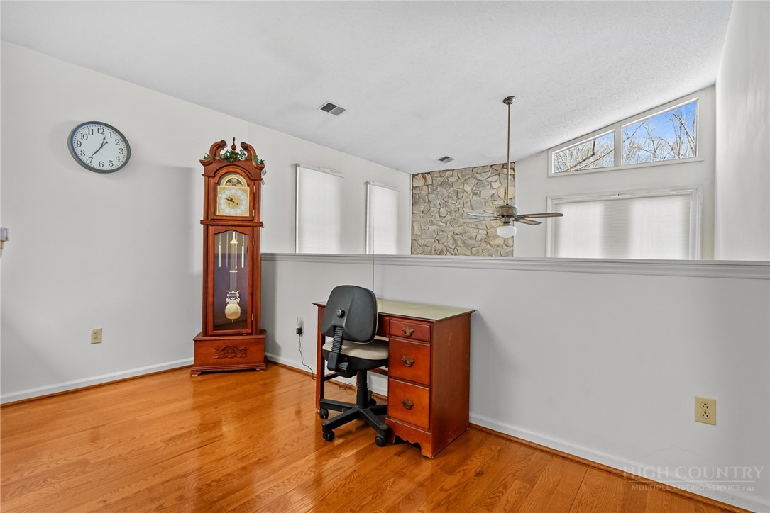 271 Quail Hollow Road Crumpler, NC 28617 - Photo 21 of 30 a view of a workspace with furniture and wooden floor
